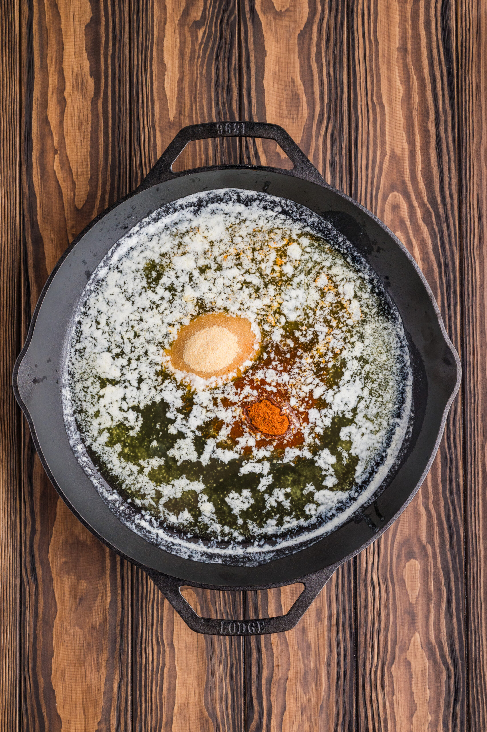 Melted butter, lemon juice, garlic powder, and Old Bay seasoning in a skillet.
