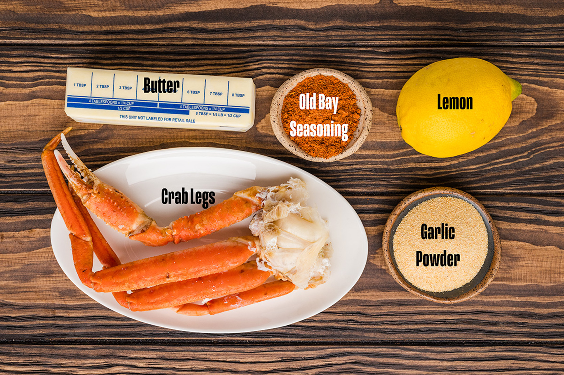 Ingredients to make these crab legs on a table.
