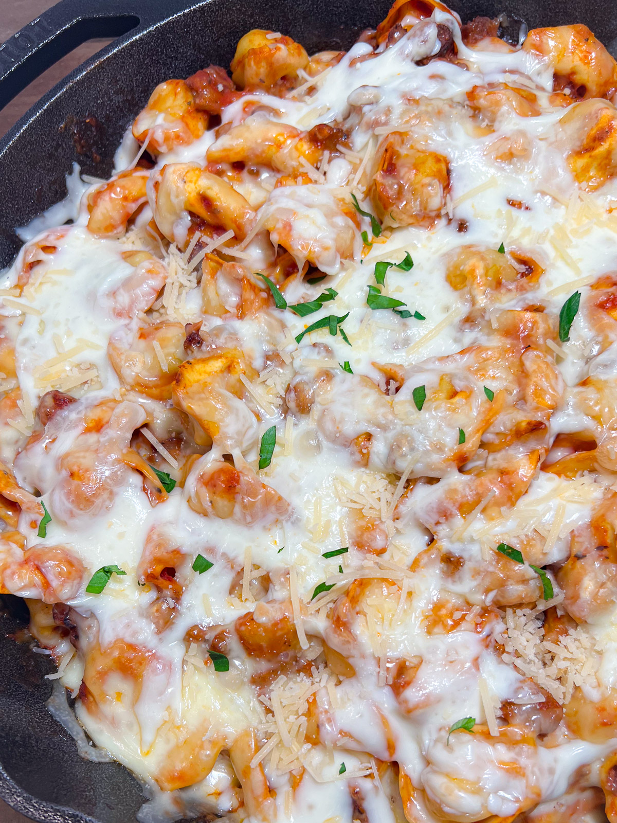 Baked tortellini with sausage fresh from the oven with melted cheese