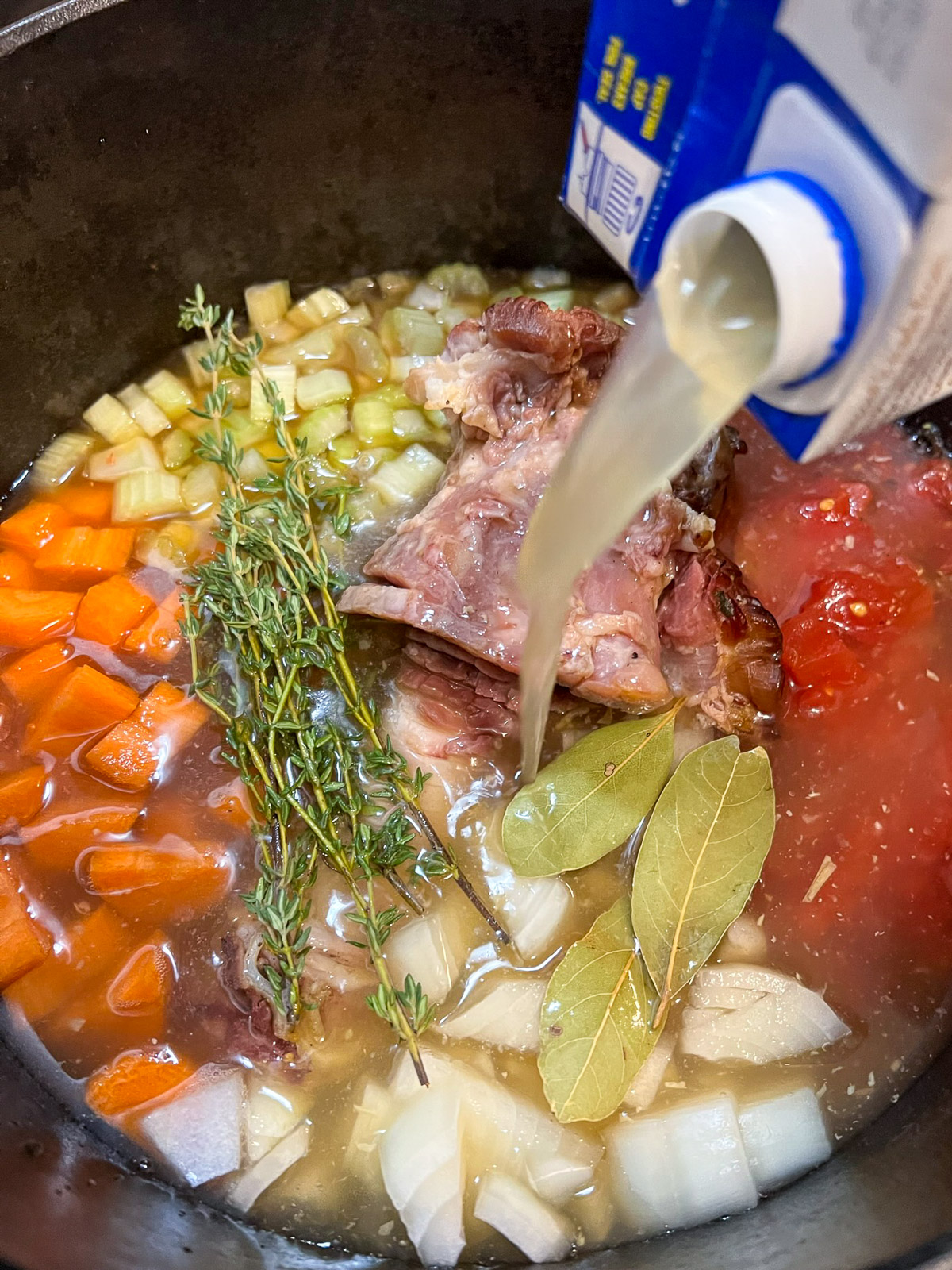 Broth added to the Dutch oven with ham and vegetables