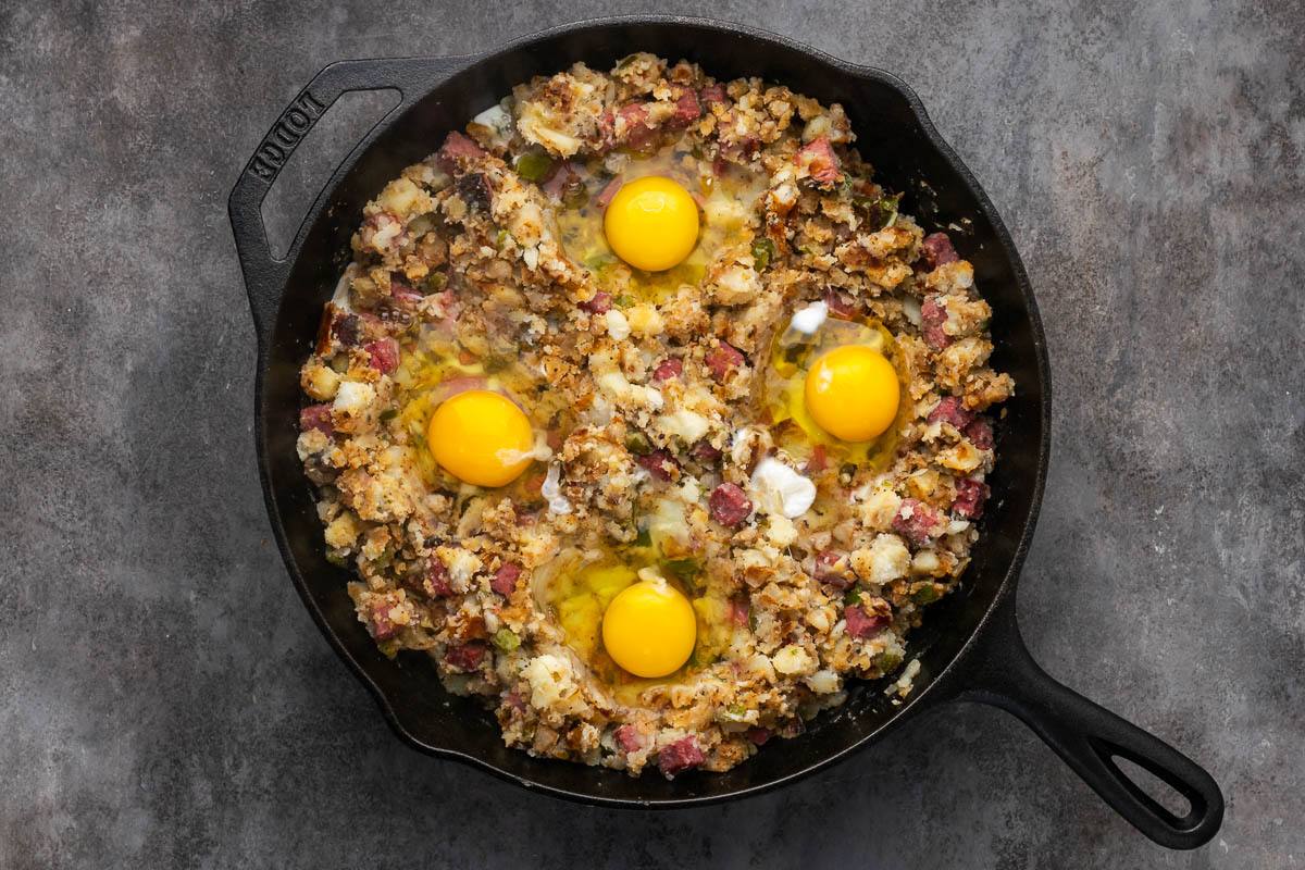 Eggs cracked into the hash to cook.