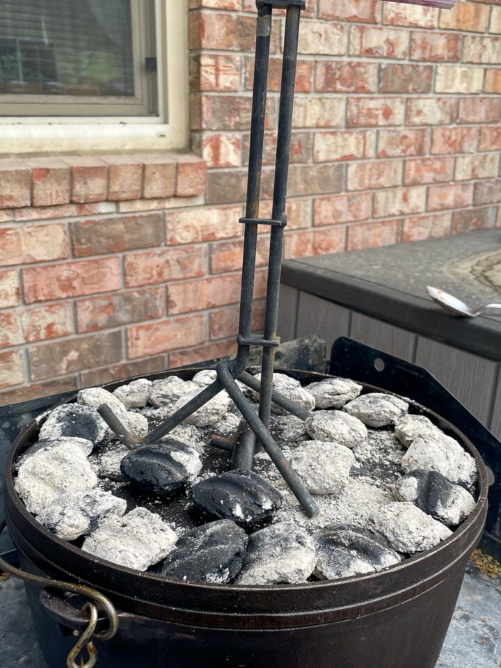 Dutch oven with white-gray coals on lid - visual heat cues replace a temperature chart