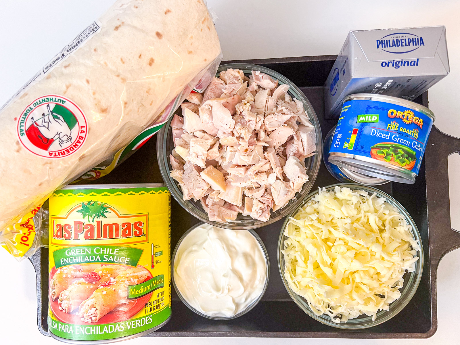 Ingredients for creamy green chile chicken enchiladas laid out on a countertop