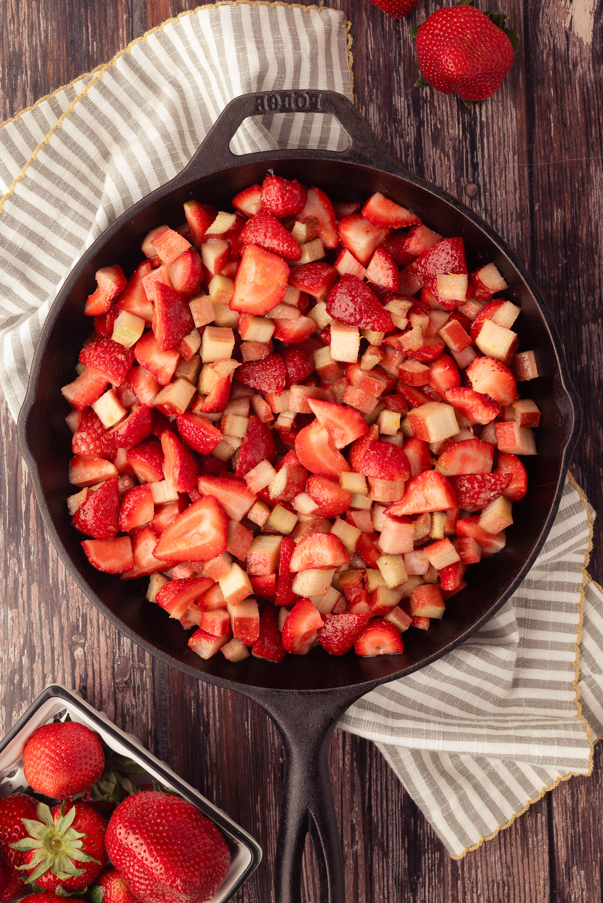 Strawberry rhubarb filling spread in a cast iron skillet