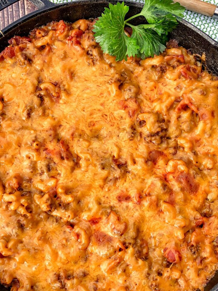 Cheesy bacon cheeseburger casserole in a cast iron skillet.