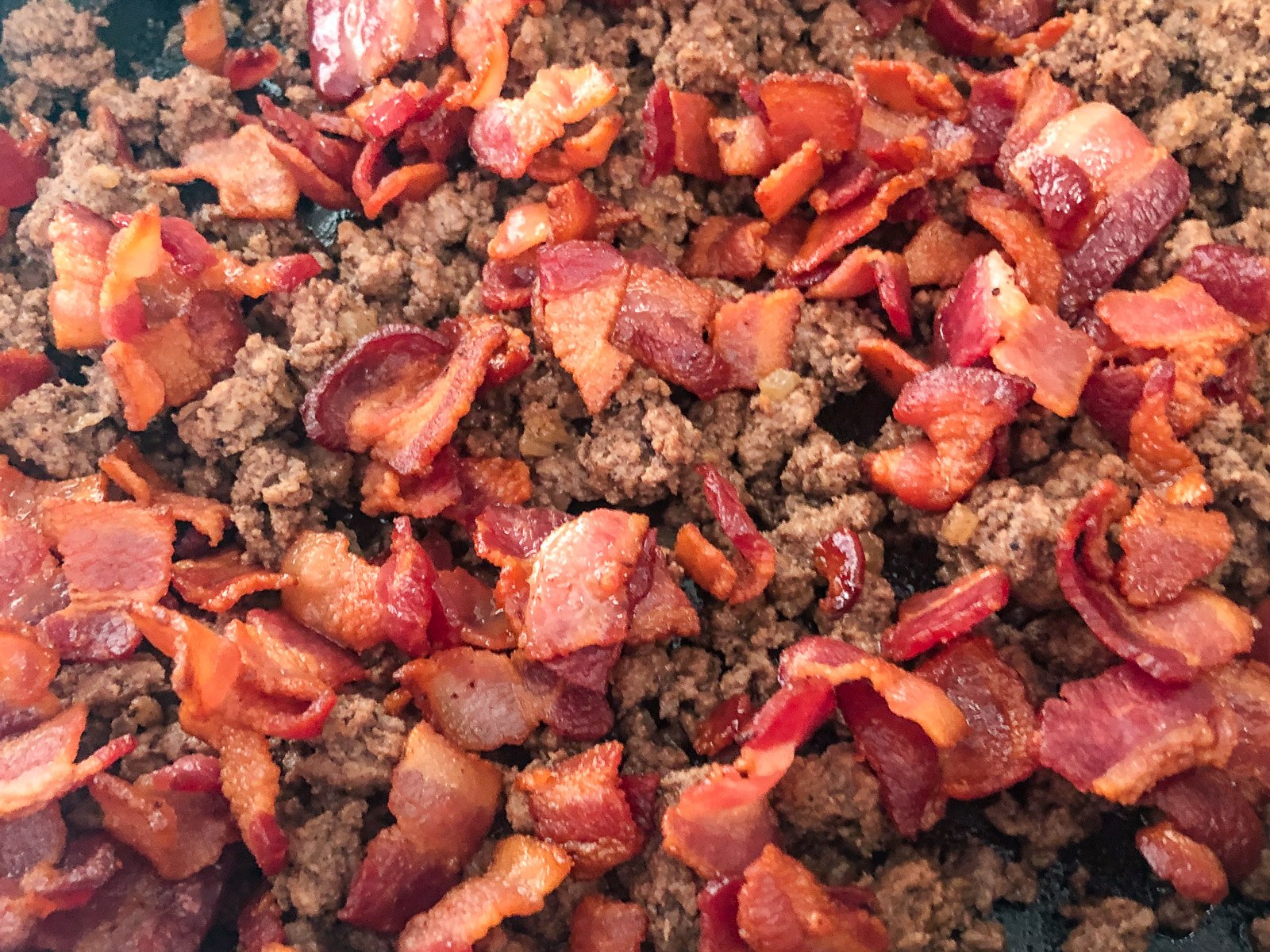 Crispy cooked bacon for bacon cheeseburger casserole.