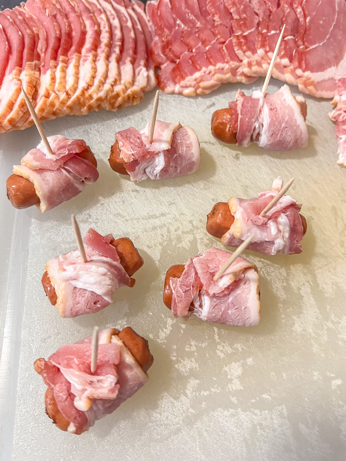 Bacon wrapped little smokies secured with toothpicks.
