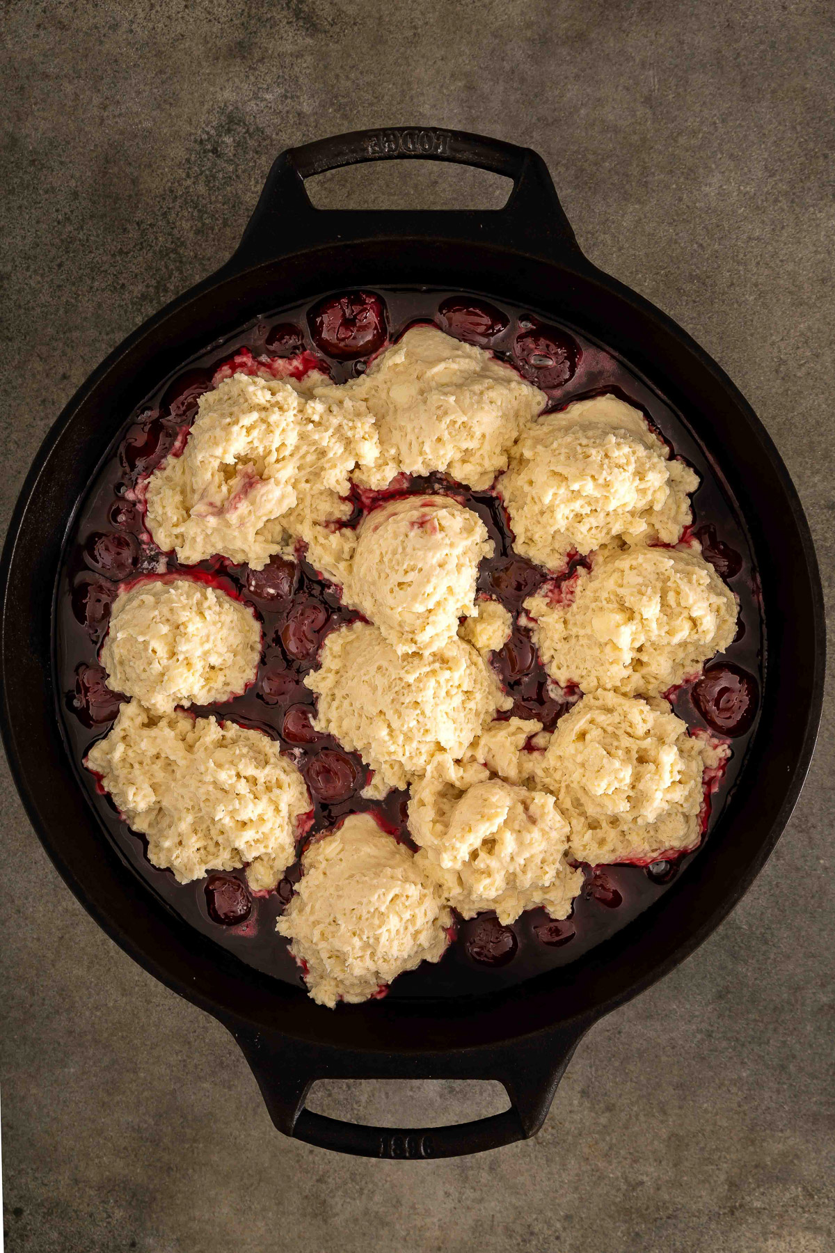 Biscuit dough mounds dropped over the cherry filling