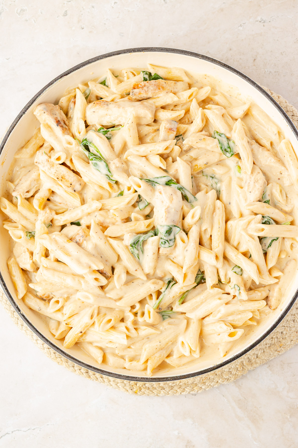 Penne pasta tossed into the creamy spinach sauce