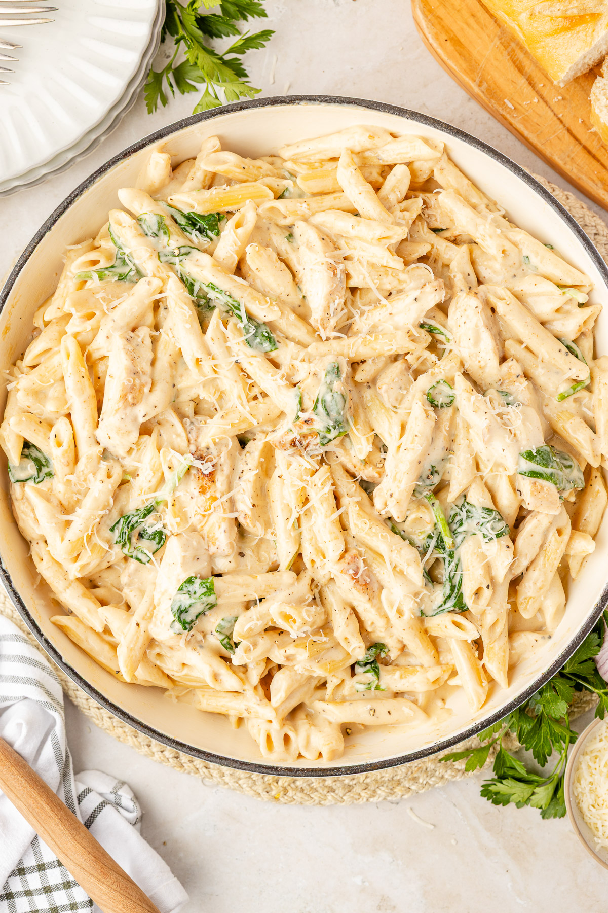 Overhead cast iron skillet of creamy chicken Florentine pasta with spinach