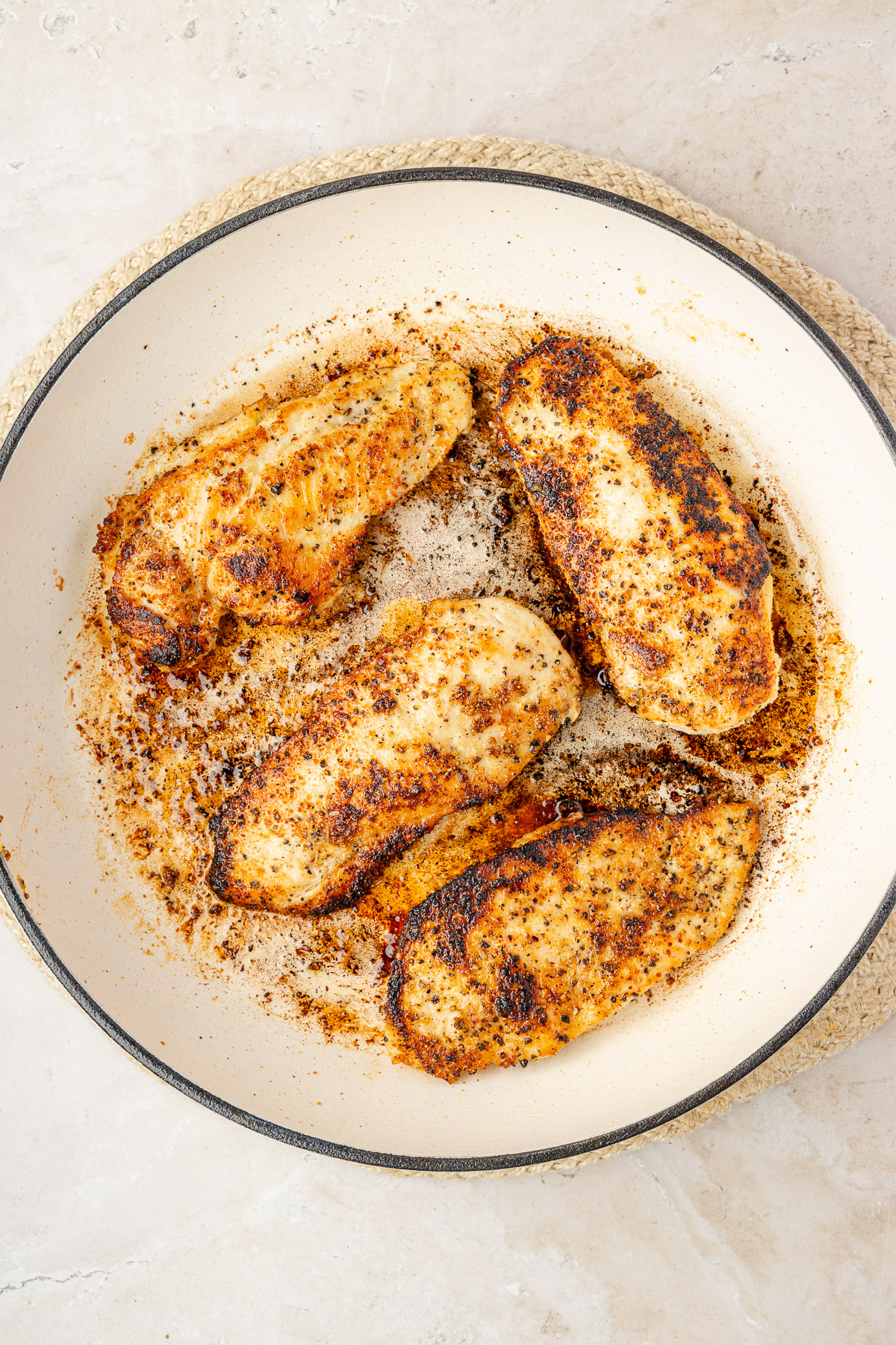 Golden seared chicken breasts resting on a plate