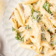A plate of creamy chicken Florentine pasta with penne and spinach