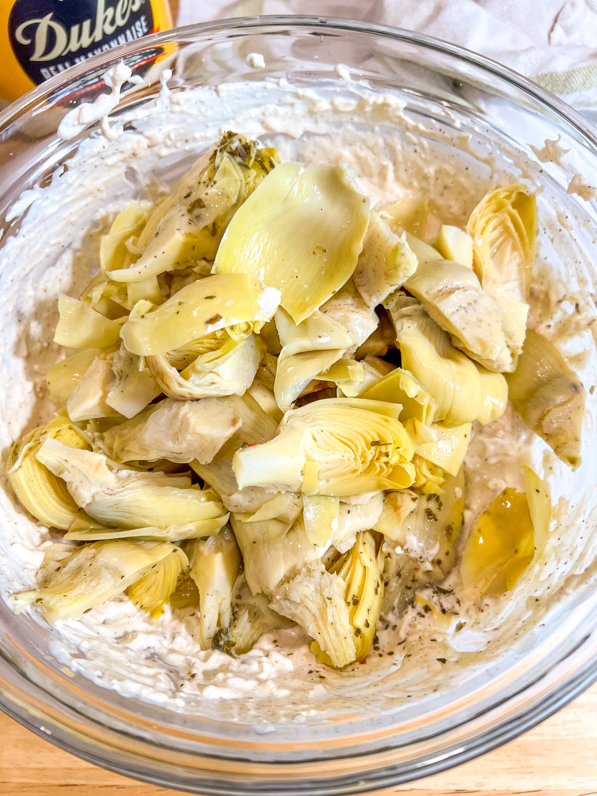 Marinated artichoke hearts added to the creamy dip base.
