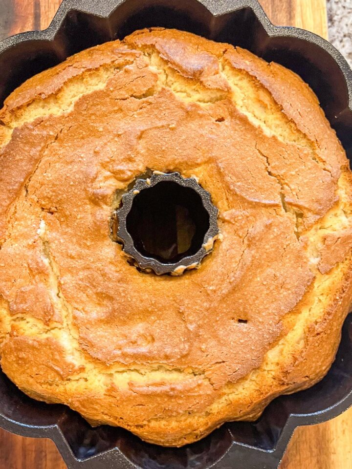 White almond cake baked in a cast iron bundt pan.