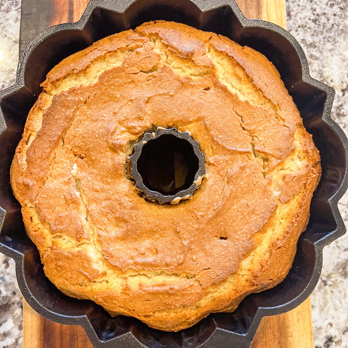 White almond cake baked in a cast iron bundt pan.