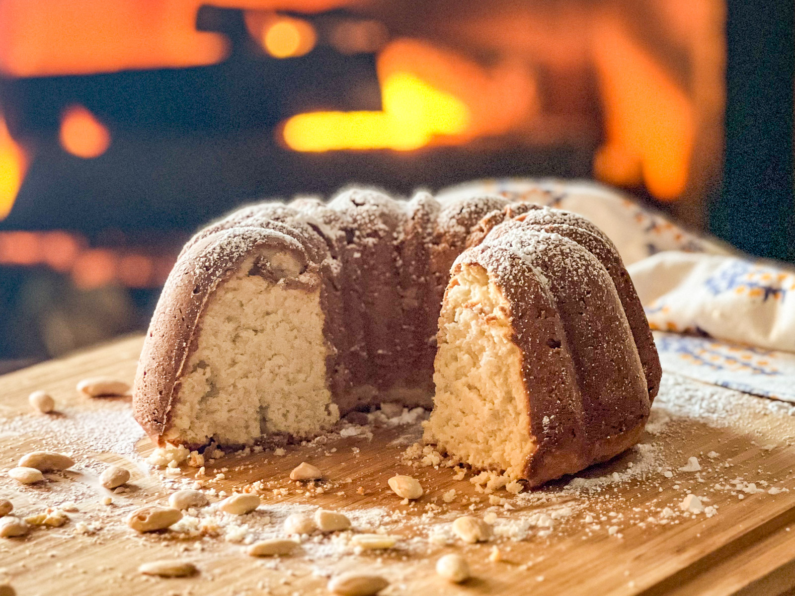 White almond cake by the fire, baked in cast iron.