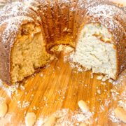 Sliced white almond cake showing the tender white crumb.