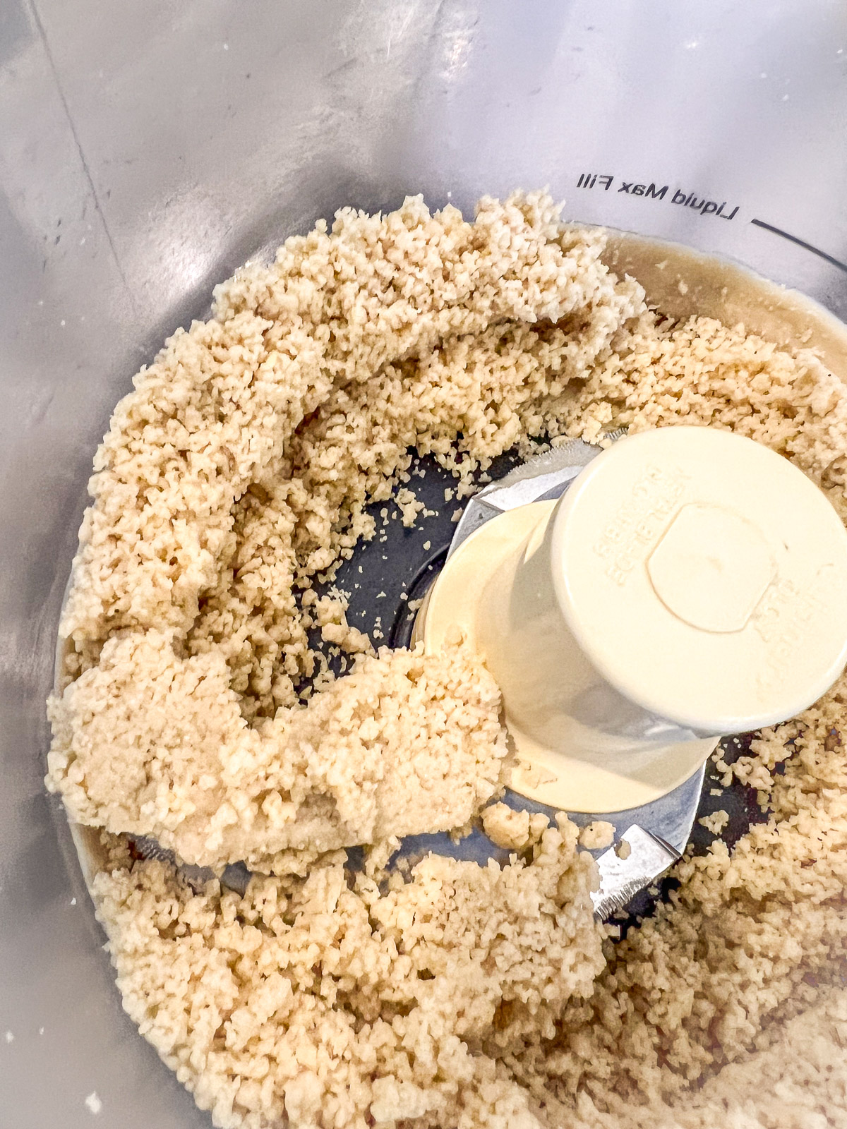 Blanched almonds ground into almond flour in a food processor.
