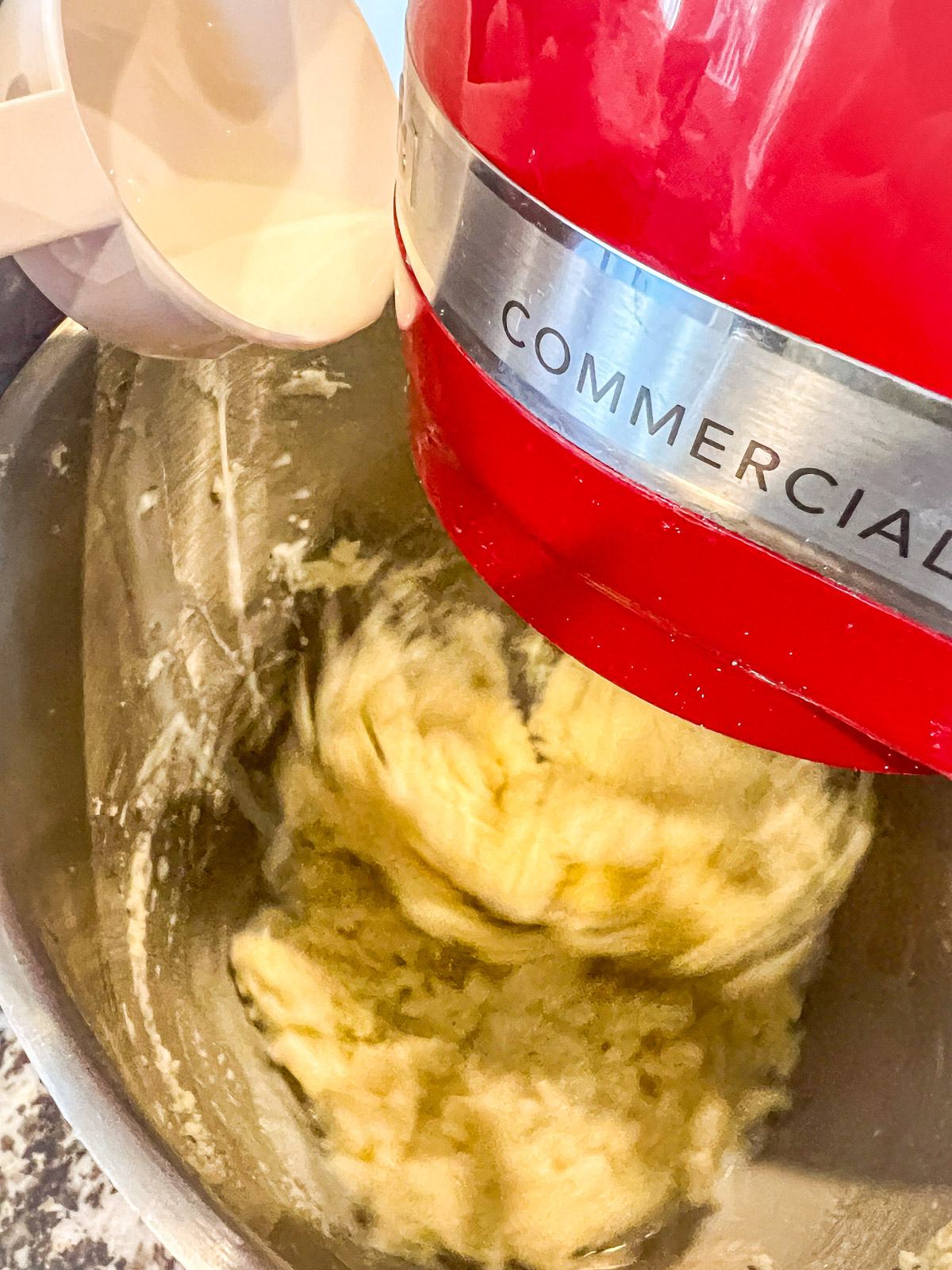 Creaming butter and sugar for almond bundt cake batter.