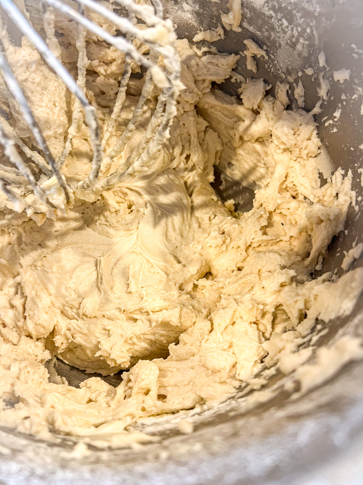 Folding ground almonds into the white almond cake batter.