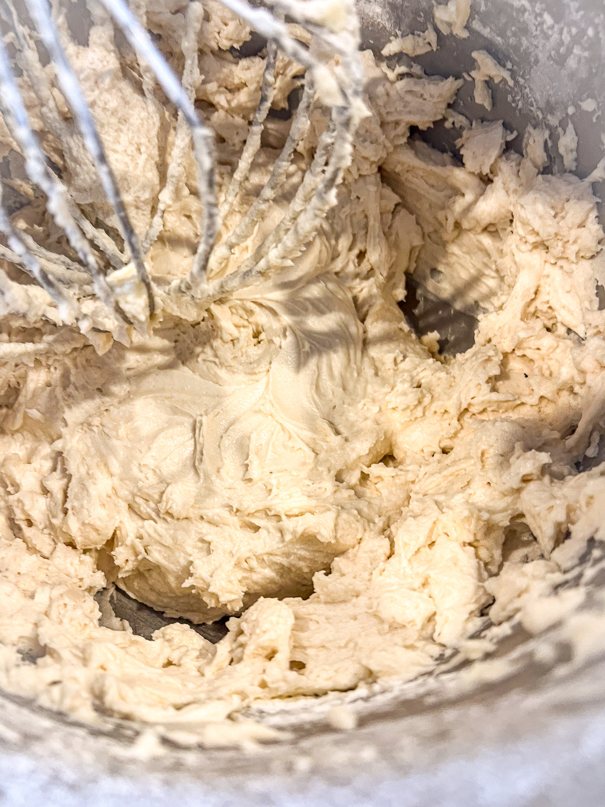 Whipped egg whites folded into white almond cake batter.
