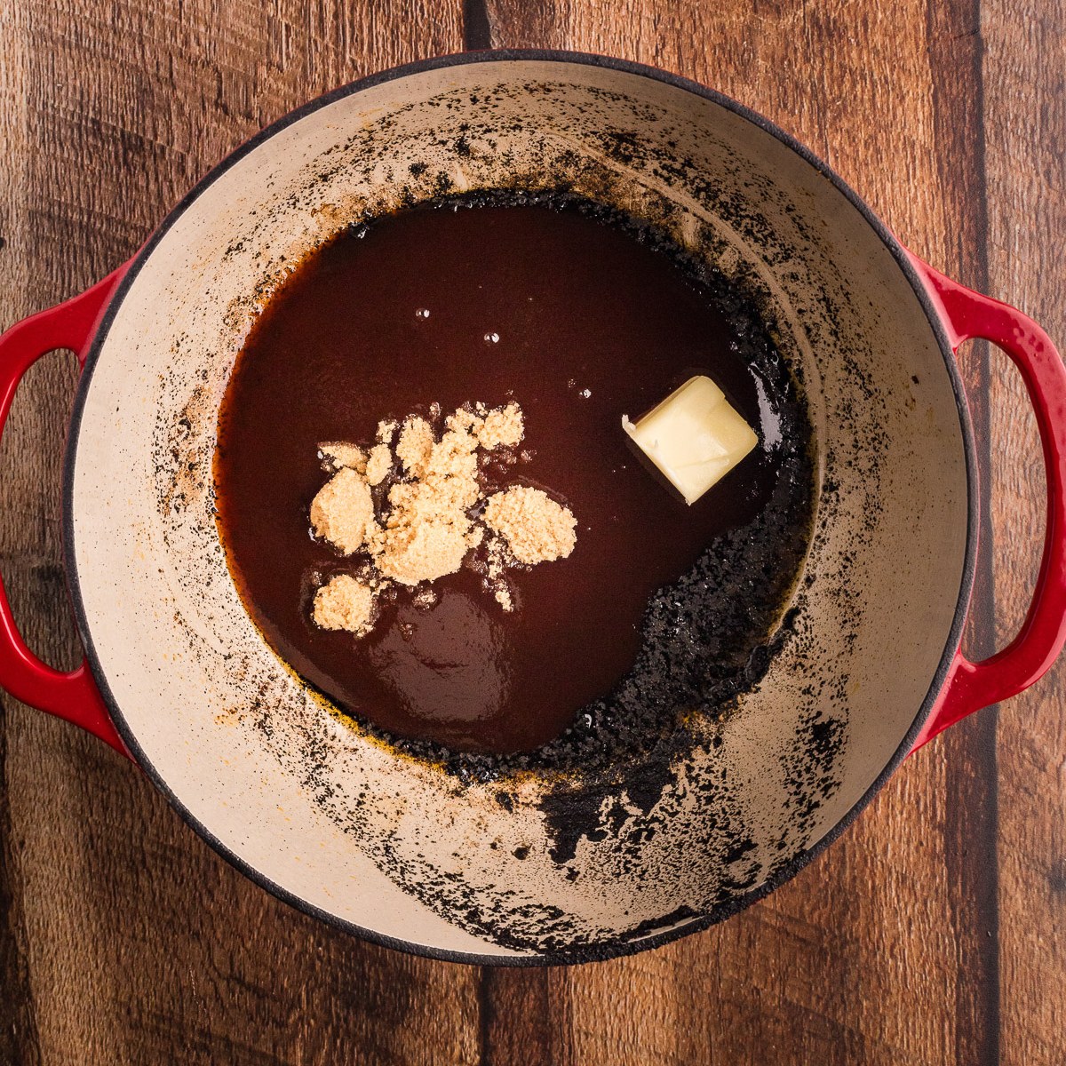 Building the BBQ butter and honey braising glaze in the Dutch oven