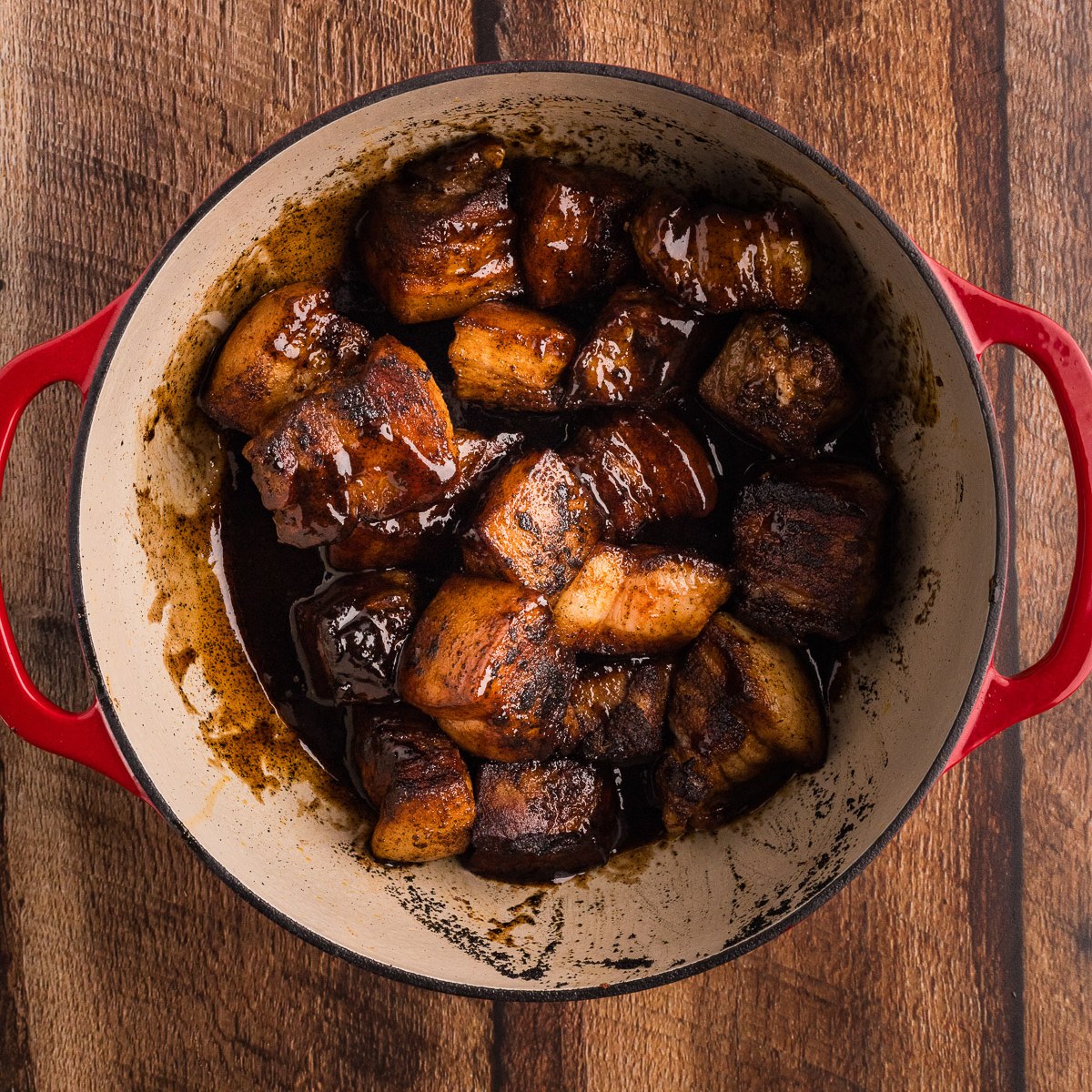 Pork belly cubes coated in BBQ glaze before braising