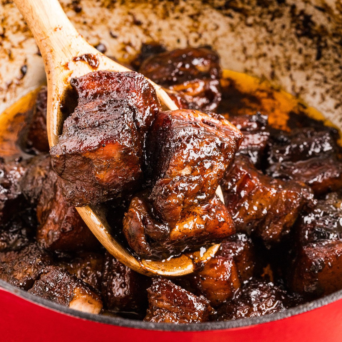 Serving sticky pork belly burnt ends with a spoon