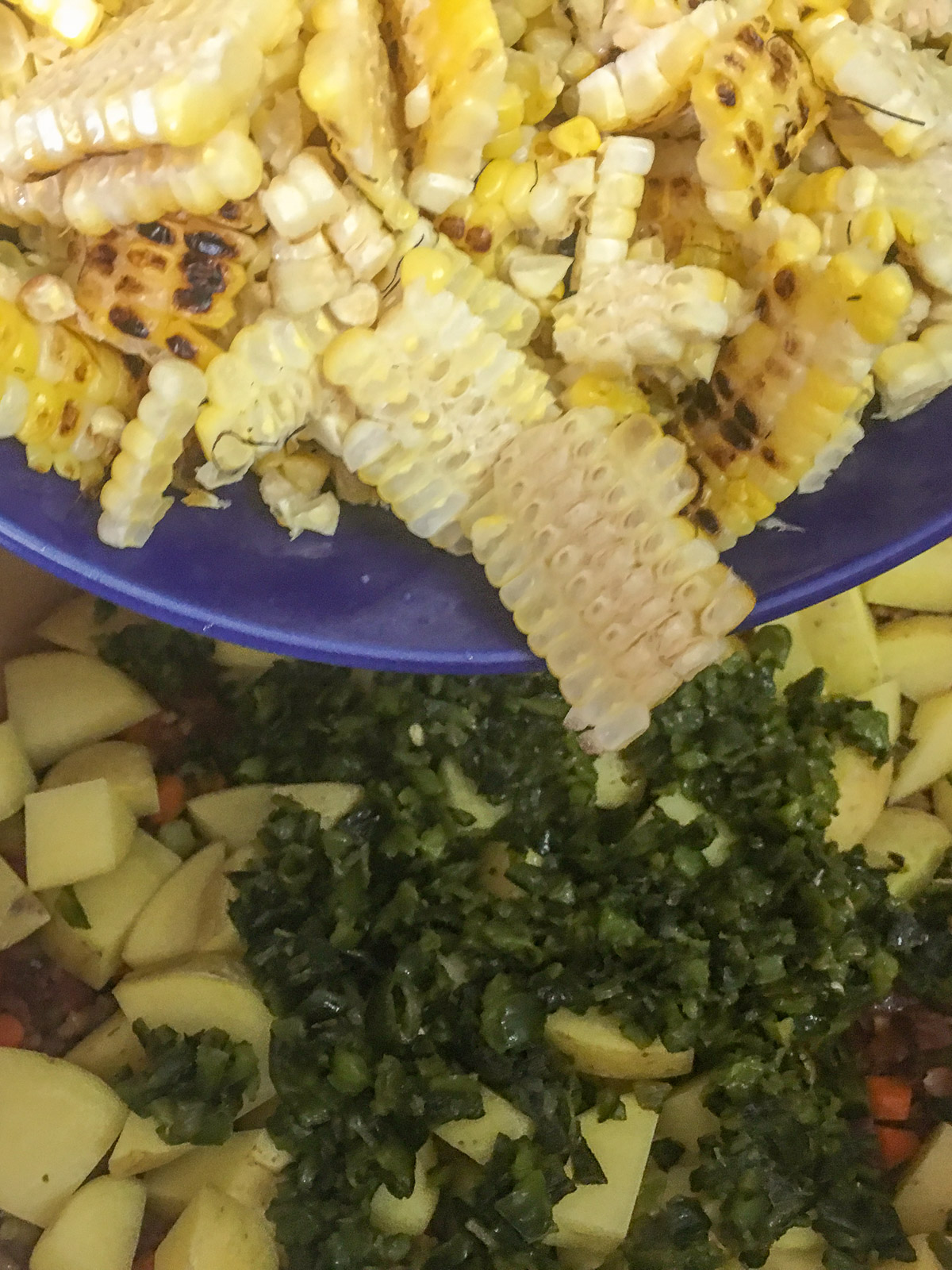 Potatoes, chopped poblanos, and roasted corn added to the Dutch oven.
