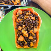 A stuffed butternut squash half plated and ready to serve.