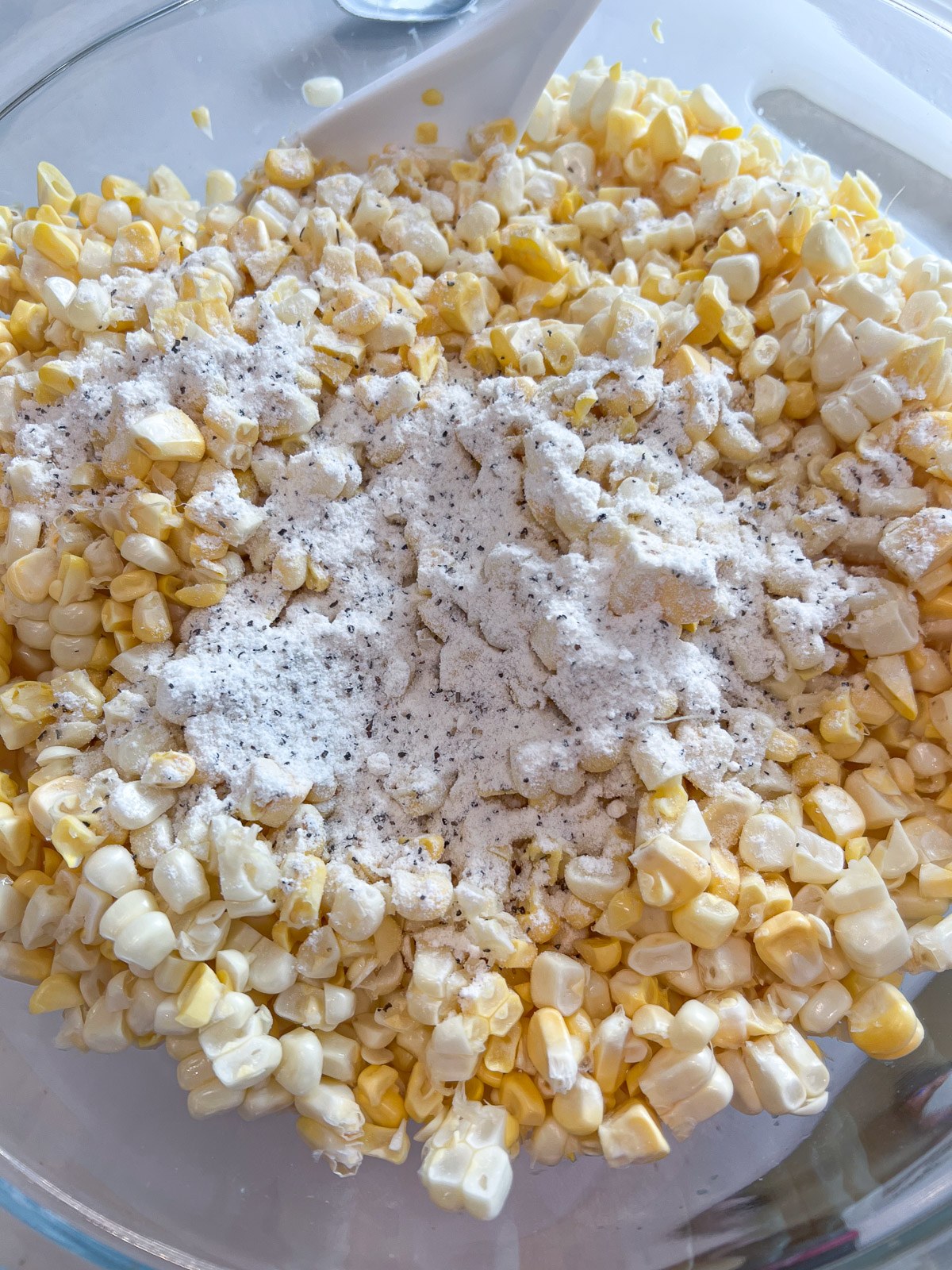 Fresh corn kernels tossed with the seasoned flour mixture.