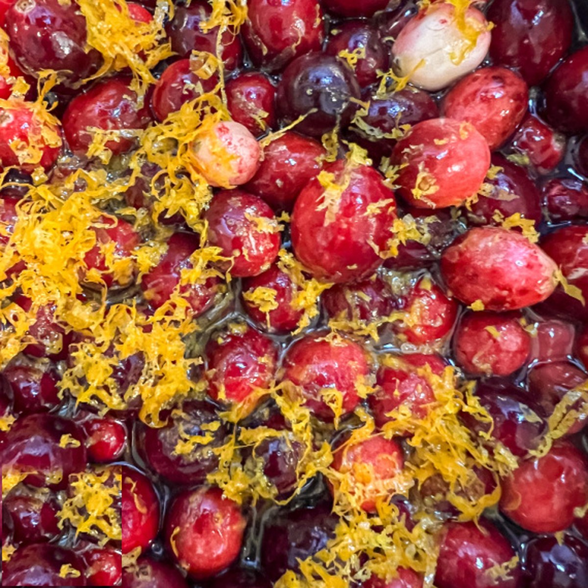 Fresh orange zest added to the cranberries in the pot.