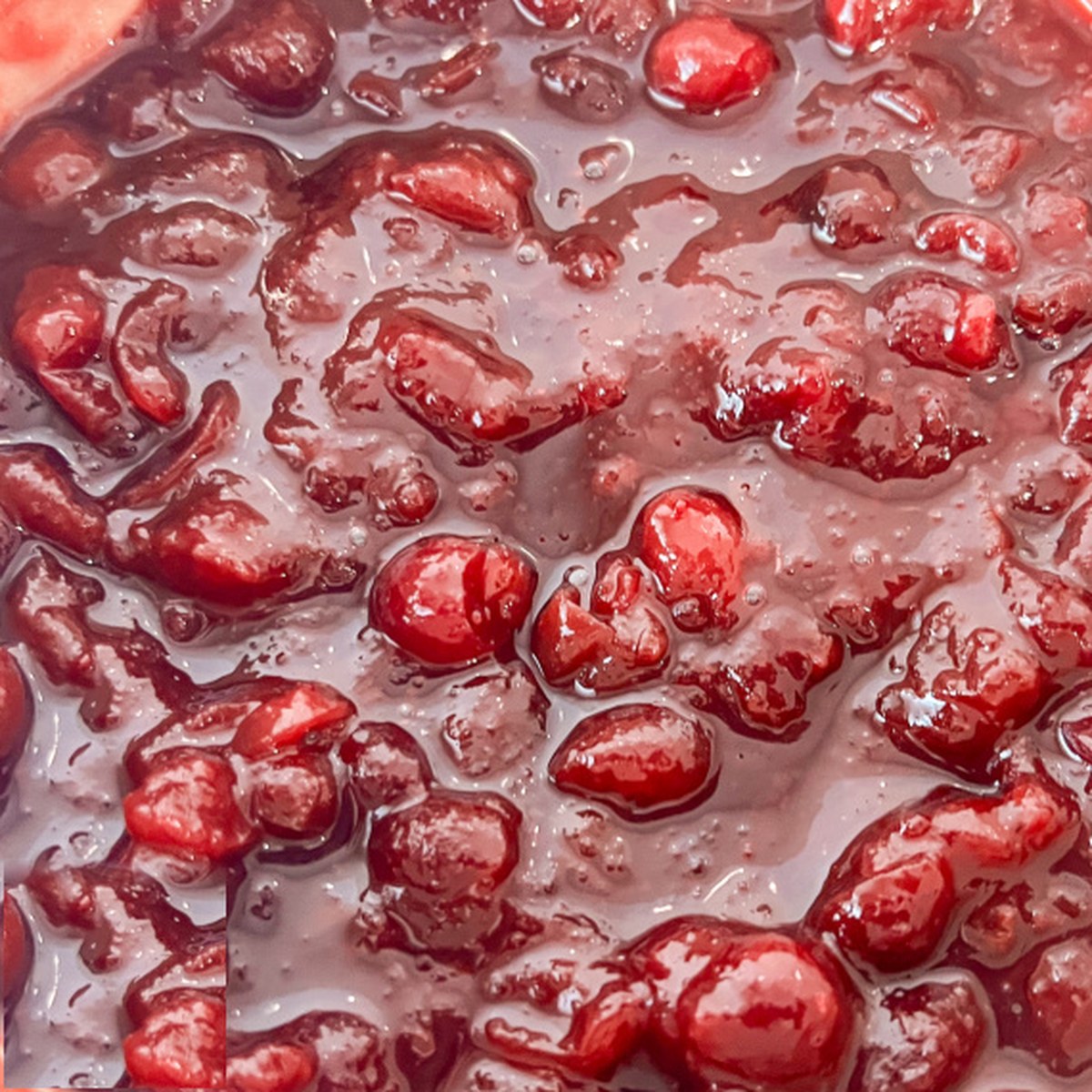 Finished homemade cranberry sauce simmered to a thick, glossy texture.