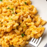 Creamy dutch oven mac and cheese served on a white plate with parsley