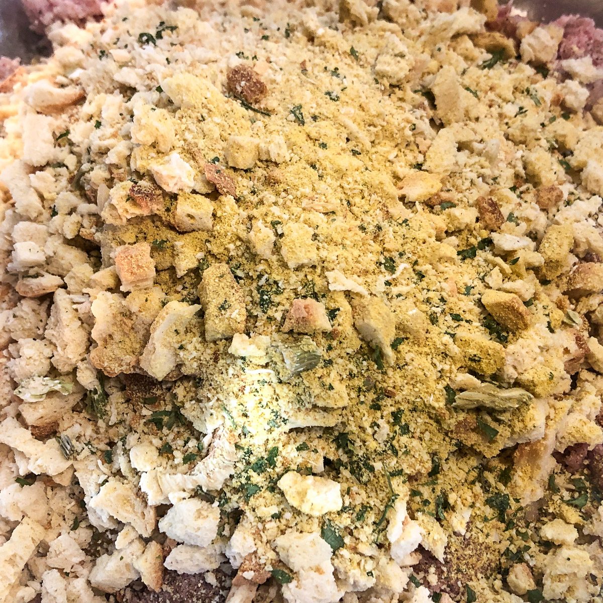 The stuffing mix and ground meat fully combined and ready to shape into meatballs.