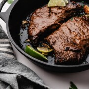 Marinated steak seared whole in a cast iron skillet