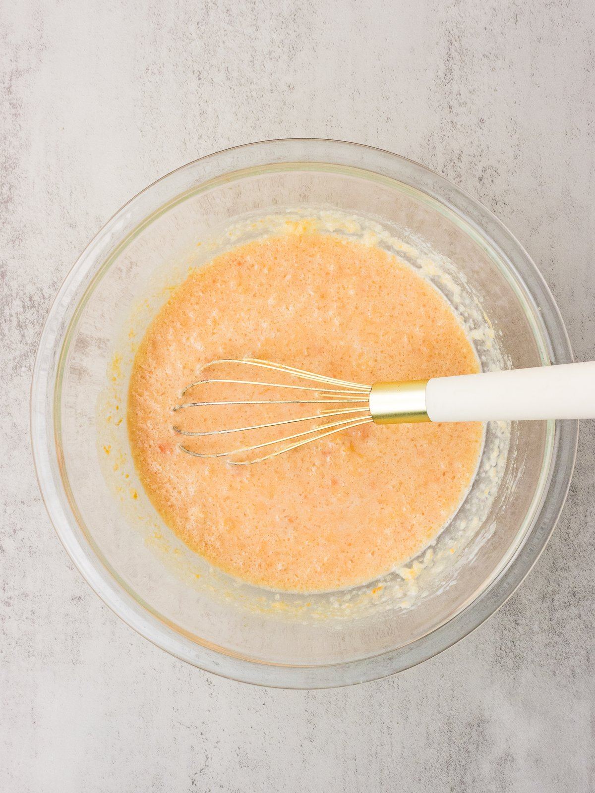 Wet ingredients for sweet potato cornbread whisked smooth in a mixing bowl