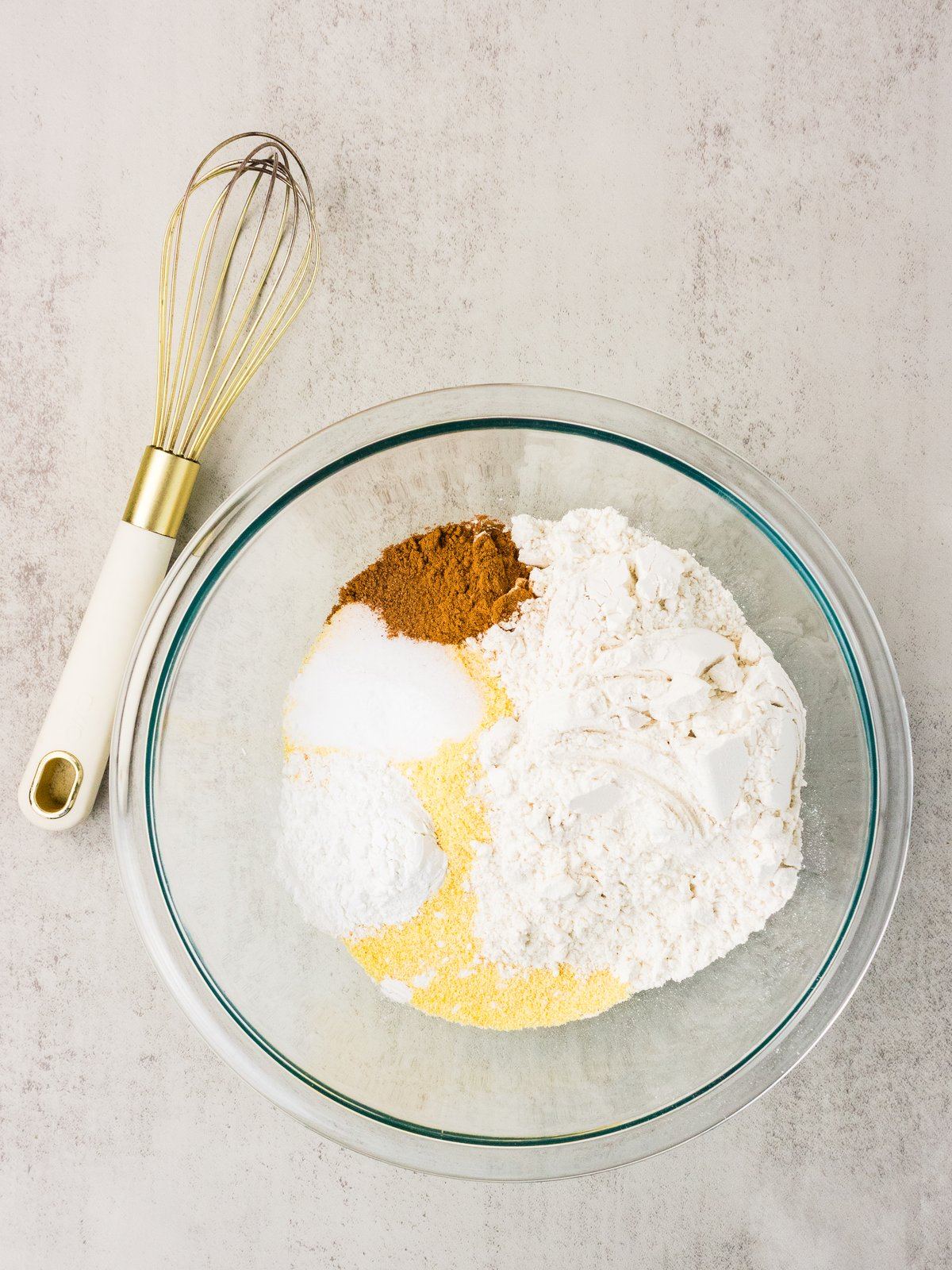 Cornmeal, flour, and warm spices in a bowl for sweet potato cornbread