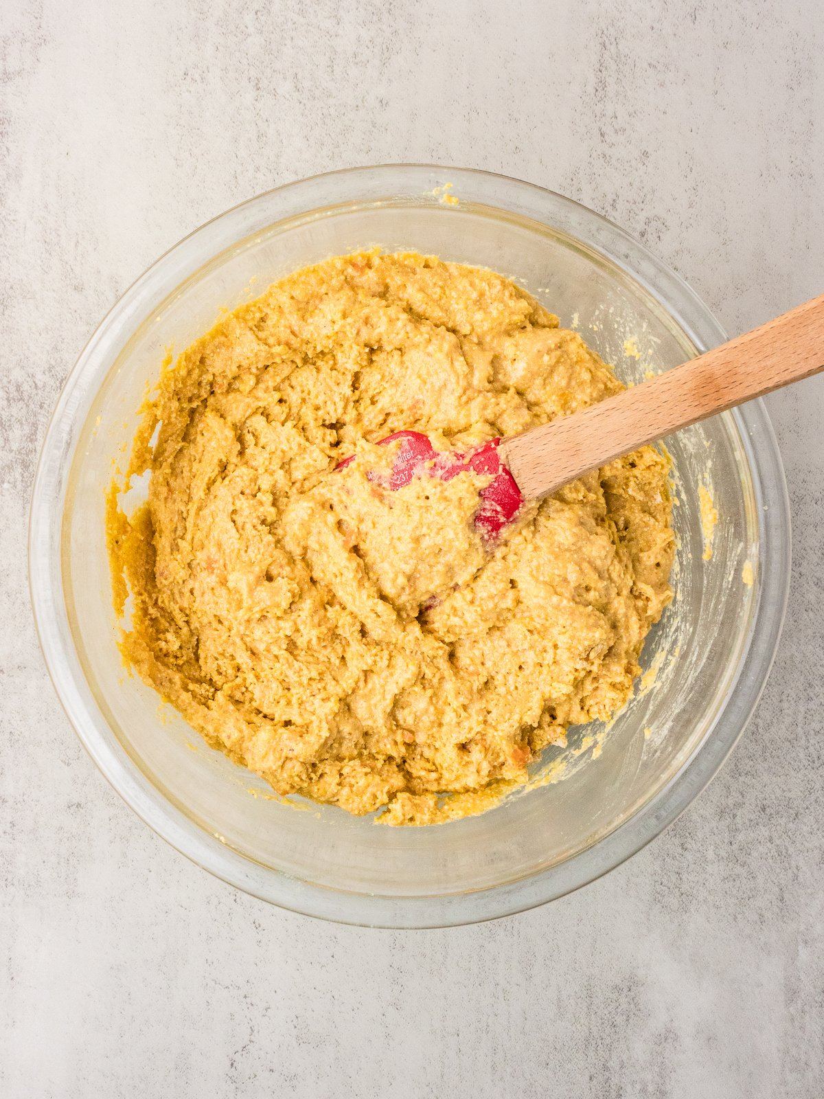Sweet potato cornbread batter folded together with a rubber spatula