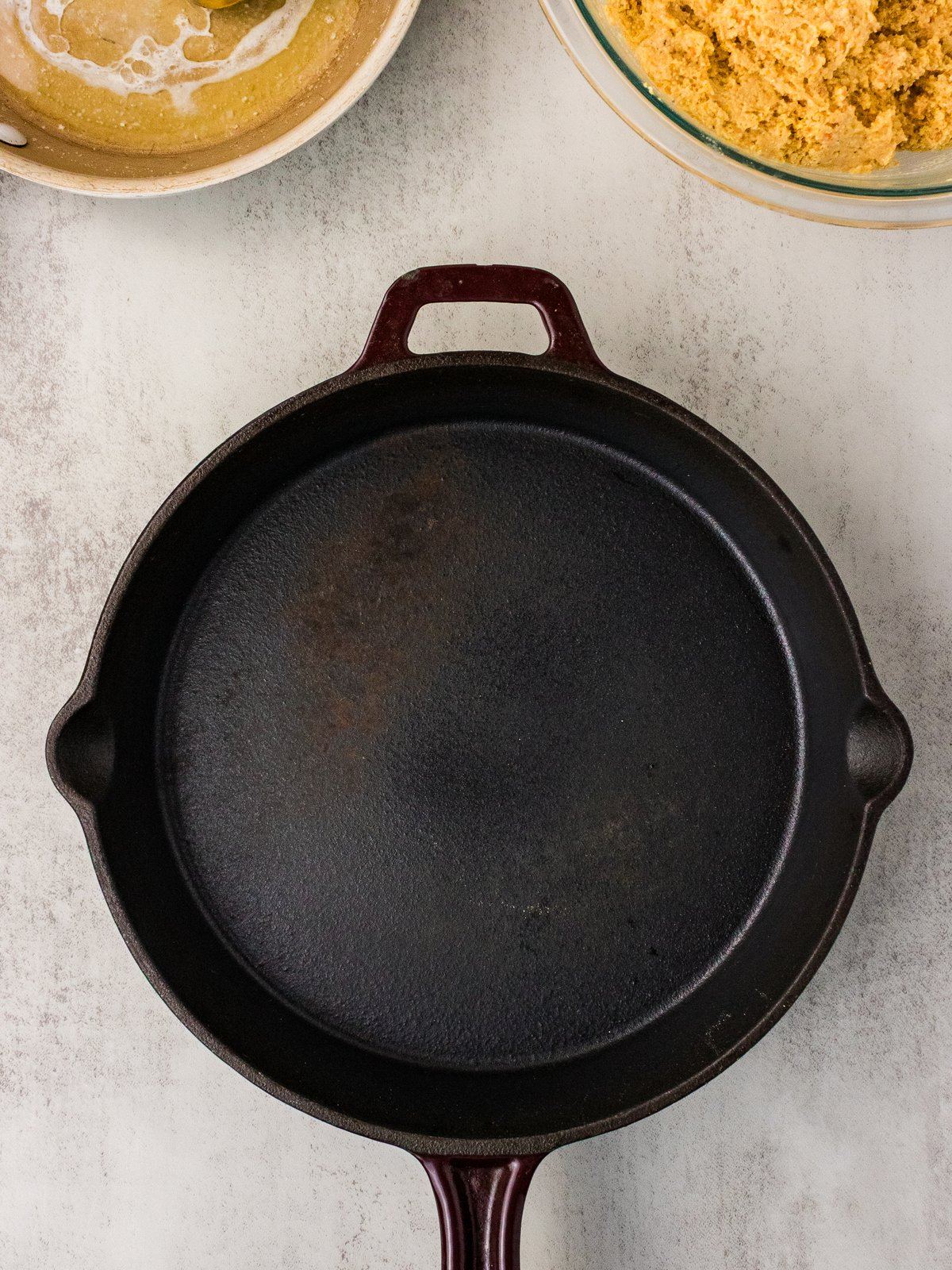 Empty preheated cast iron skillet ready for the sweet potato cornbread batter