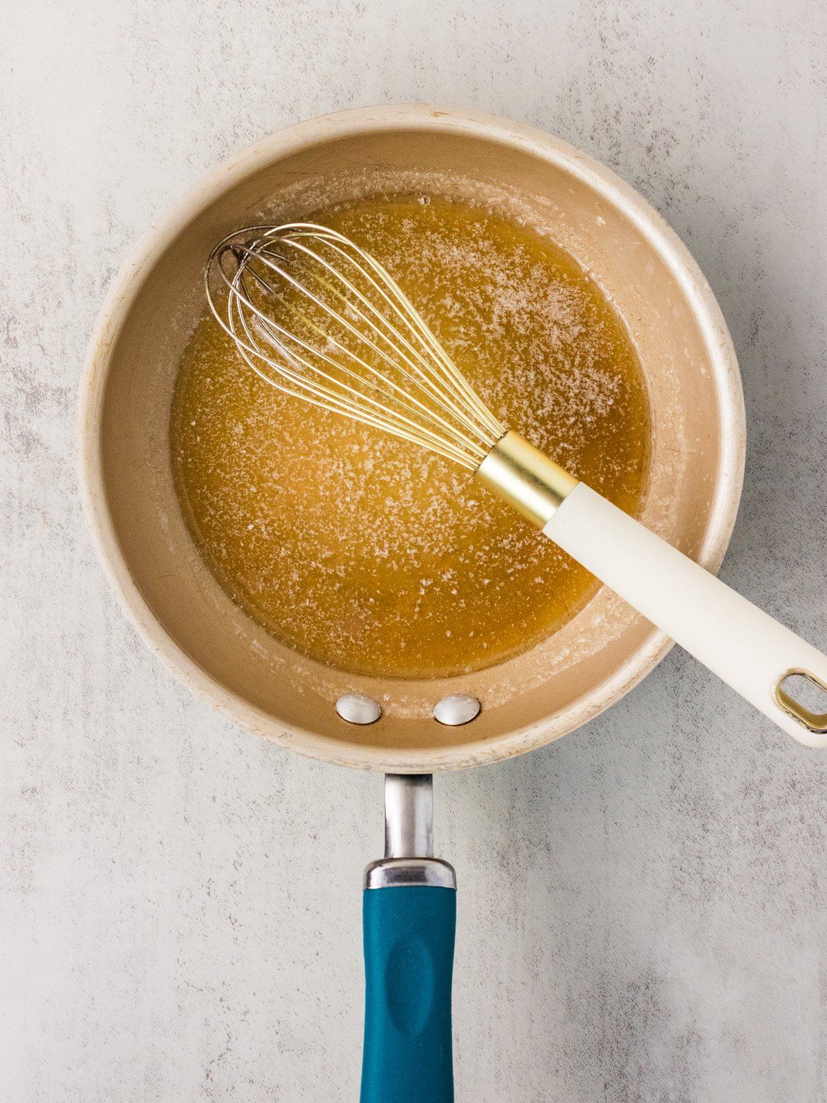 Brown butter for the maple glaze turning golden in a small saucepan