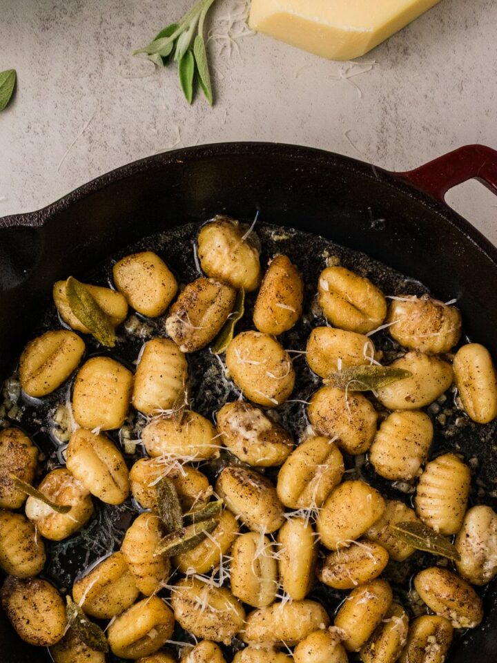 Crispy brown butter sage gnocchi in a cast iron skillet