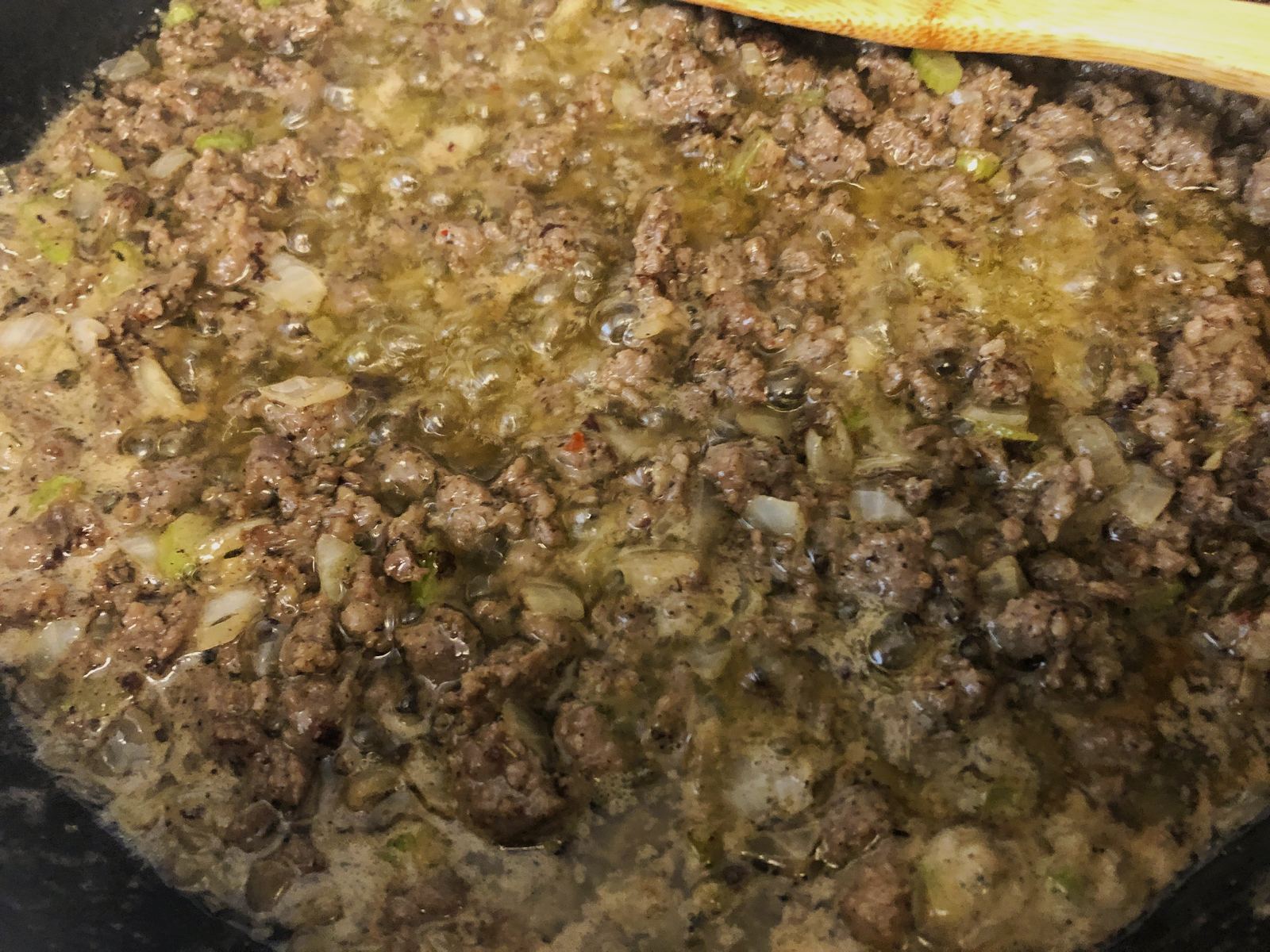 Cooked sausage stirred back into the buttery onion and celery in the skillet.