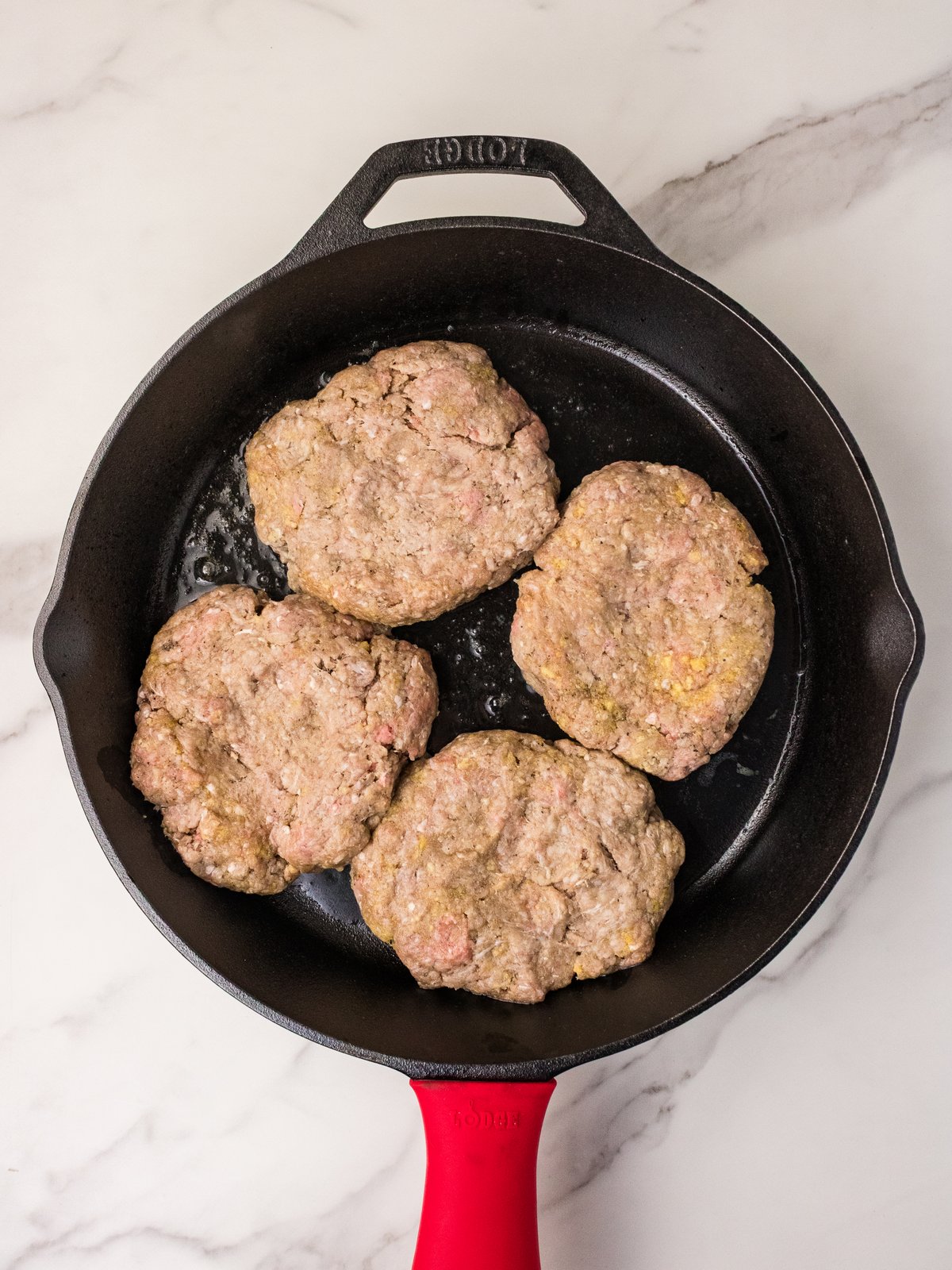 Hamburger steaks searing in cast iron skillet