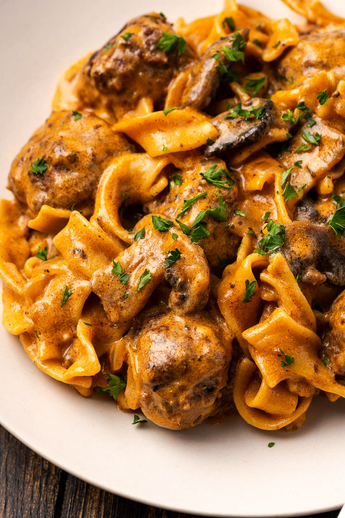 Close-up of tender meatballs, mushrooms and egg noodles in creamy stroganoff sauce